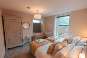Whaley BridgeThe Jodrell Luxury Suites的一间卧室设有两张床和窗户。