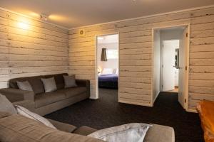 陶波陶波哈卡小屋旅舍的带沙发的客厅和卧室