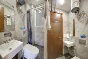 古尔冈FlxHo Quad - Luxury Studio Apart Hotel DLF Cyber City的一间带水槽、卫生间和淋浴的浴室