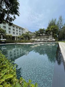 峇都丁宜孤松酒店的大楼前的游泳池