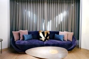 成都成都W酒店的客厅配有一张紫色沙发,配有一张桌子