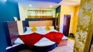 乌贾因New G P Guest house的一间卧室配有一张床铺,床上铺有红色毯子