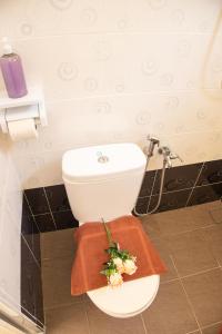 关丹Sweet Inn Guest House的浴室设有鲜花和卫生间。