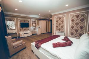甘贾Baku Hotel Ganja的一间卧室配有一张床和一把椅子