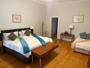 桑兰德Beyond Cui Bono的一间卧室设有两张床,铺有木地板