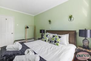 伦敦Parea Living - Stylish Islington 1-Bed Flat, 6min Walk to Tube的卧室配有一张带白色床单和枕头的大床。