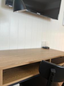 Herøy Brygge的一张木桌,在房间内配有一张黑椅子