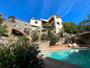 赫罗纳Luxury Villa Girona Bellissimo的山丘上带游泳池的房子