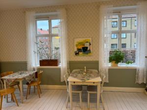 兰斯克鲁纳STF Landskrona Hostel的用餐室设有2张桌子和2个窗户