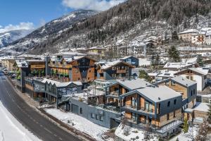梅扎纳Hotel Ravelli Luxury Spa的雪地中度假小镇的空中景观