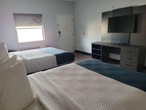 GonzalesStudio 6 Gonzales TX的酒店客房设有两张床和电视。