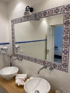 伊斯基亚海王别墅住宿加早餐旅馆的一间带水槽和镜子的浴室
