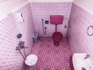 乌提Heaven Bungalow的粉红色的浴室设有卫生间和水槽