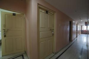 那格浦尔SPOT ON Shraddha Hotel的墙上有两扇门的空走廊