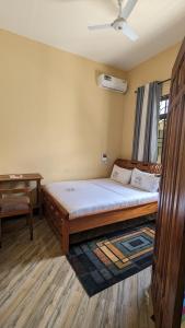 达累斯萨拉姆Rest Inn Lounge & Lodge的一间卧室配有一张大床和一张书桌