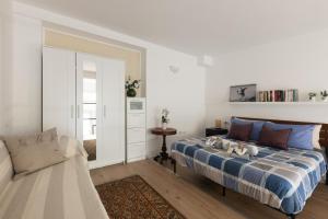 米兰Moderno e Confortevole Loft tra Navigli e Bocconi的一间卧室配有一张床和一张沙发