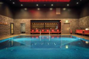 斯德哥尔摩Elite Hotel Marina Tower, Spa & Resort的带沙发的房间内的大型游泳池