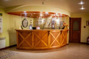 乌斯怀亚布雷西亚别墅酒店的一间设有时钟的房间里的大型木制酒吧