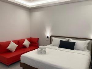 瓜拉比拉CS Junction Point - Double Deluxe Room - DDR的一间卧室配有两张床和一张红色沙发