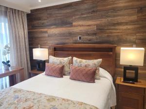 巴拉斯港Hotel Puerta del Lago的一间卧室配有一张带两盏灯的床。