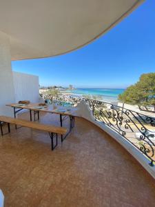 圣伊西多罗Villa GAUDÌ的阳台设有长椅,享有海滩美景