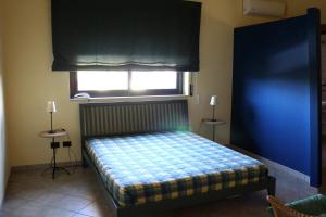 科米索Villa Sam的一间卧室配有一张蓝色墙壁和窗户的床