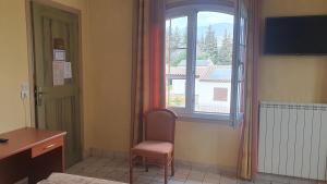 格拉斯勒斯香气酒店的客房设有窗户、椅子和书桌。
