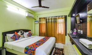 普里Goroomgo Hotel Asish Bollywood Beach View Puri - Best Choice of Travellers的一间卧室配有一张大床和一张书桌