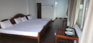 康提Oyado Marufuku的一间卧室设有两张床、一张桌子和一个窗口