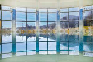 八幡平市ANA Crowne Plaza Resort Appi Kogen, an IHG Hotel的水中反射的游泳池