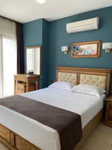 达特恰Veziroğlu Apart的一间卧室配有一张带蓝色墙壁的大床