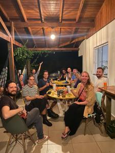 弗洛里亚诺波利斯Nômades Riverside - Adventure Hostels & Coworking的一群人坐在桌子旁