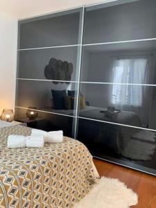 维勒帕里西L’Emeraude的卧室的反射,卧室配有一张床和镜子