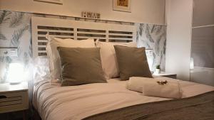 希洪Zarraci La Guía的卧室内的一张带白色床单和枕头的床