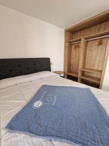 卡勒达德福斯特Hoy Caleta Apartments的床上有蓝色毛巾