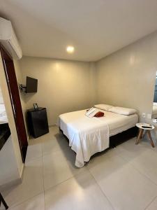 阿拉亚尔-杜卡布Morada do Sol Suítes的一间酒店客房,配有一张床和一台电视