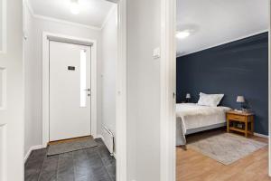EidsvollCozy and central home near Oslo Gardermoen Airport的一间卧室设有一张床和蓝色的墙壁