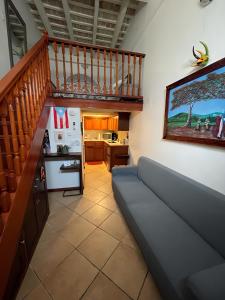 圣胡安Old San Juan Historic Loft 4 The Adventurous的带沙发和楼梯的客厅