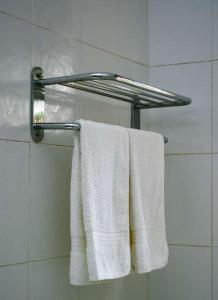 坎帕拉Naalya Motel的浴室内带白色毛巾的毛巾架