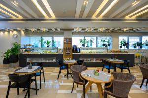 阿萨夫哈罗芬班古里昂机场萨杜特酒店 - 阿特拉斯精品酒店的一间带桌椅和柜台的餐厅
