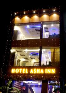 JasidihHotel Asha Inn的一座建筑,晚上有酒店灰 ⁇ 标志