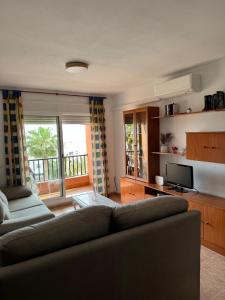 滨海罗克塔斯Apartamento Roquetas playa con WIFI的带沙发和电视的客厅