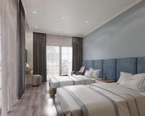 后川Wonderland Villa Hồ Tràm Beach的酒店客房设有两张床和窗户。