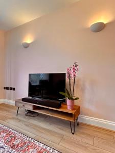 TimperleyNature Inspired Bungalow with 3 rooms - 10 mins from Manchester Airport的客厅配有大屏幕平面电视