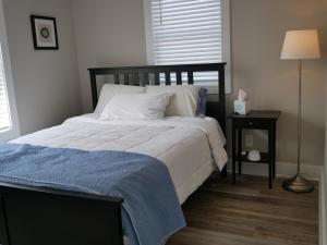 北托普塞尔海滩Beach Star Villa的一间卧室配有一张带蓝色毯子和一张桌子的床。