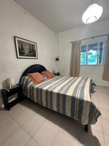 SaladilloA CAZON QUITADO的一间卧室配有带条纹毯子的床