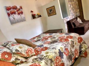 科潘玛雅遗址Habitación Doble Mayan Plaza的一间卧室配有一张带鲜花毯子的床