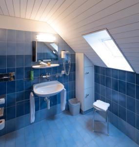 施泰因Hotel Adler的蓝色的浴室设有水槽和卫生间
