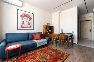 塔什干Stylish & Modern Apartment I Blueloft 48的客厅配有蓝色的沙发和桌子