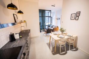 鹿特丹Warm 2 Bedroom Serviced Apartment 59m2 -LK21-的厨房以及带桌椅的起居室。